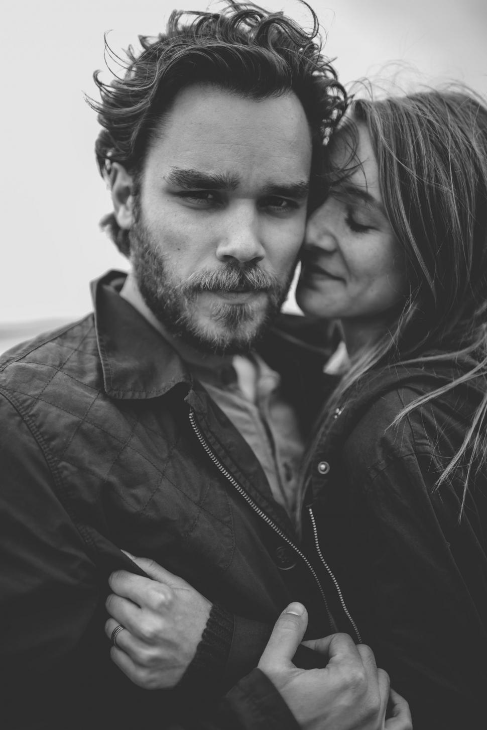 Free Image of A Man and a Woman Standing Together in Black and White 