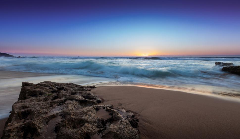 Free Image of Sunset Over Ocean on Beach 