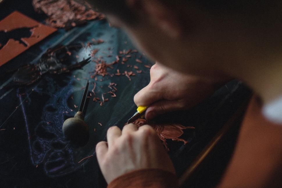 Free Image of Man Carving Wood With Scissors 