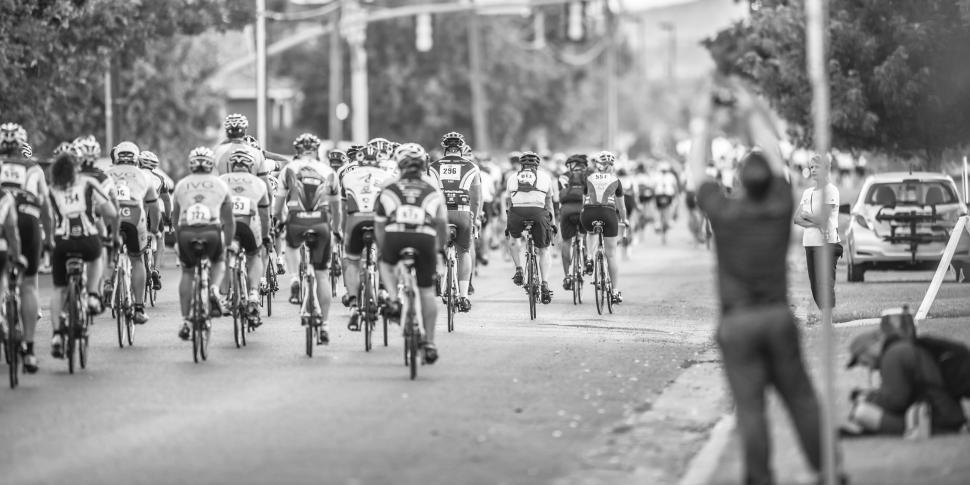 Free Image of Large Group of People Riding Bikes Down a Street 