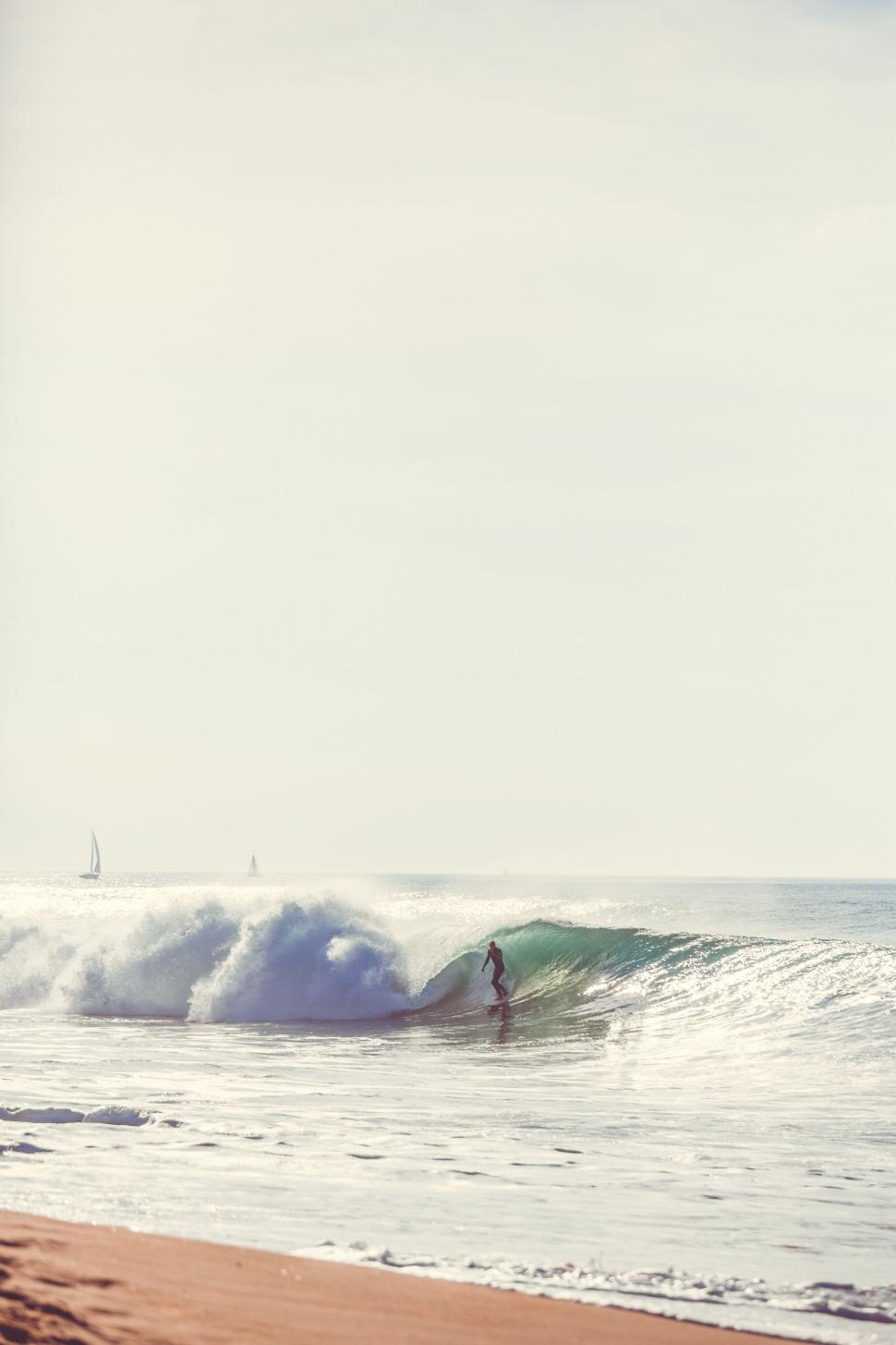 Free Image of Man Riding Wave on Surfboard 