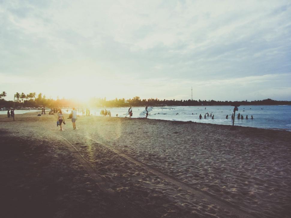 Free Image of Group of People Standing on Sandy Beach 