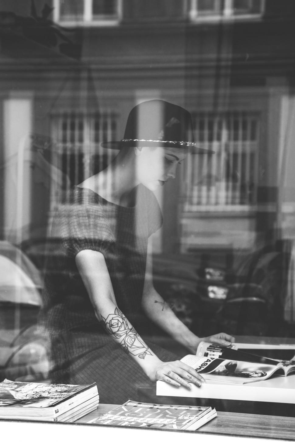 Free Image of Woman Sitting at Table by Window 