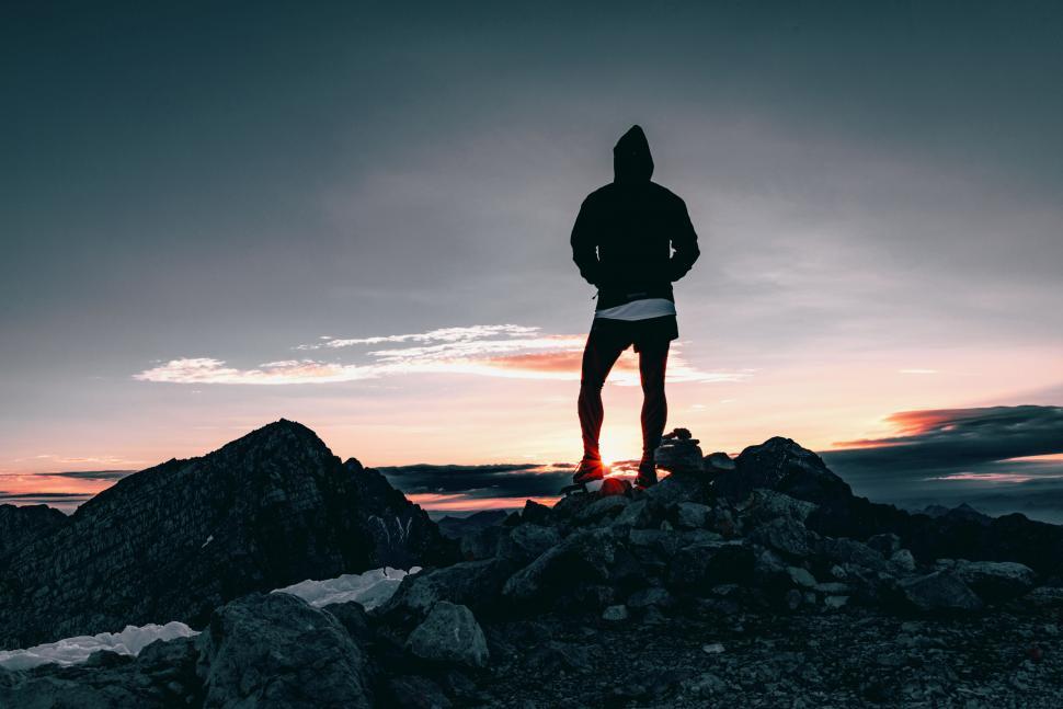 Free Image of Man Standing on Top of Rocky Mountain 