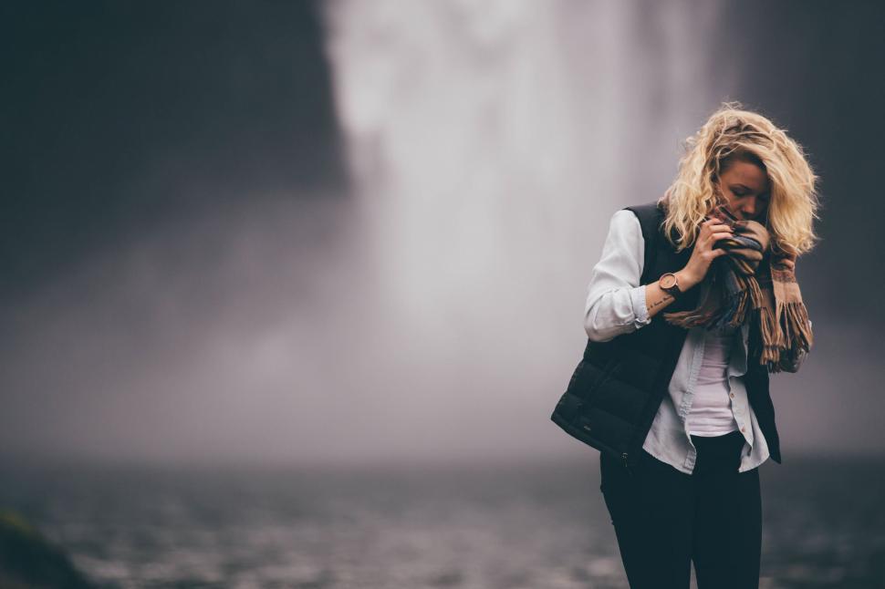 Free Image of Woman Standing in Front of Waterfall 