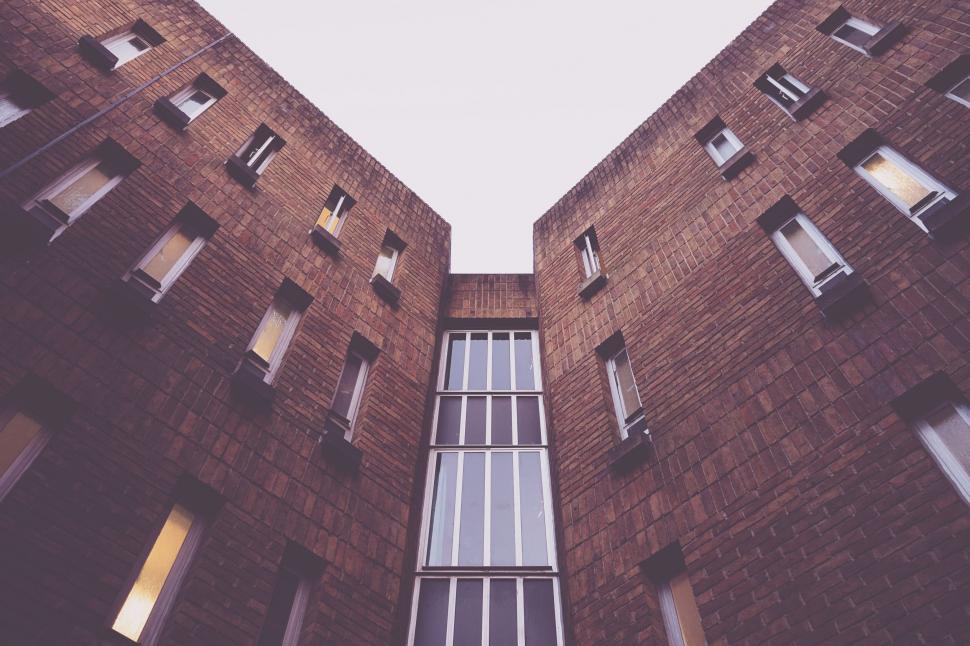 Free Image of Tall Brick Building With Lots of Windows 