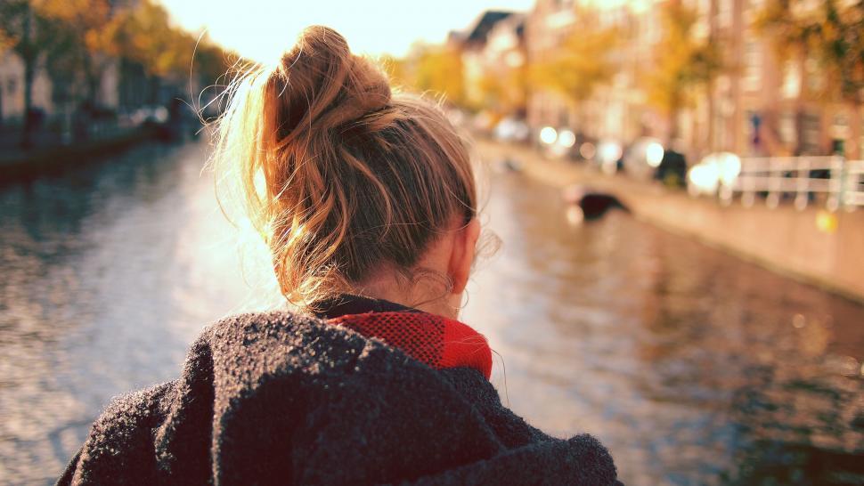 Free Image of Woman Standing on the Riverbank 