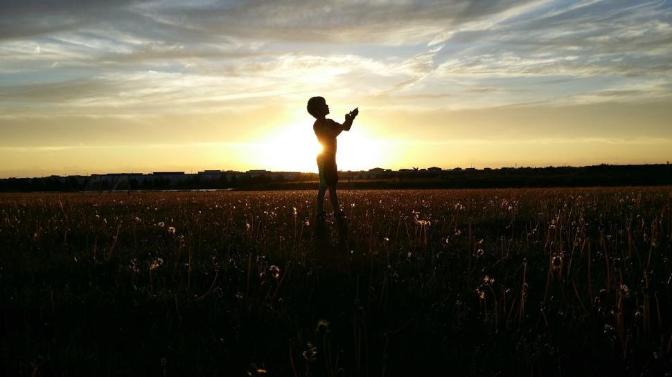 Free Image of Person Standing in Field at Sunset 