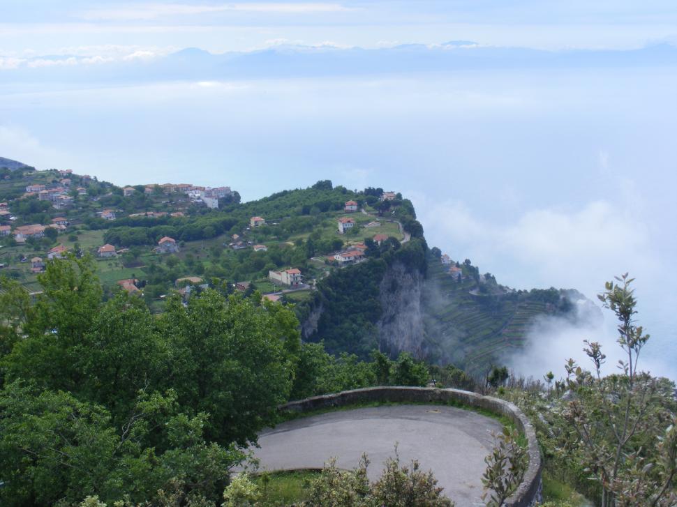 Free Image of Road, Sea and Mountain peaks under the clouds  