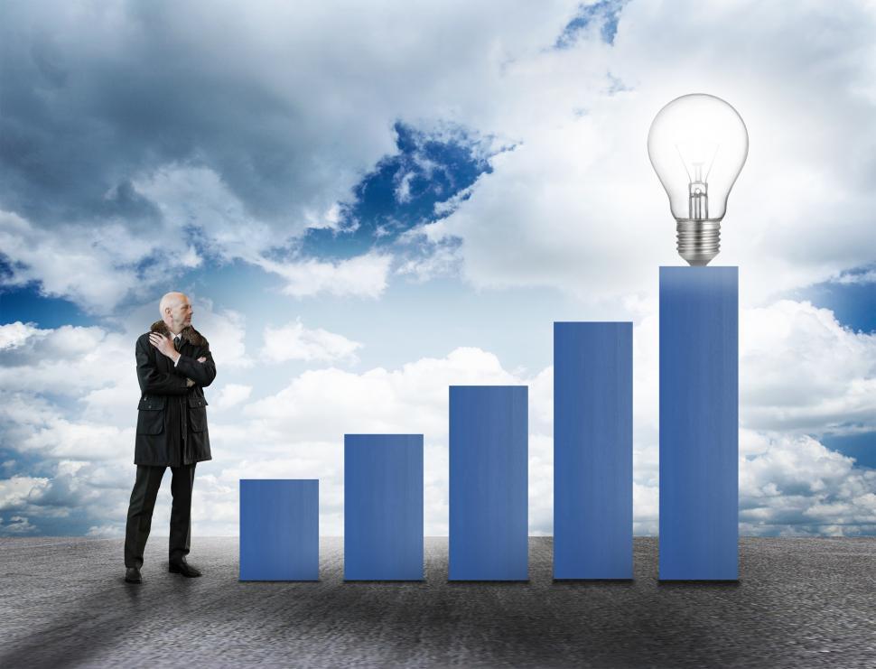 Businessman with bar chart and lightbult - Asset Growth Concept
