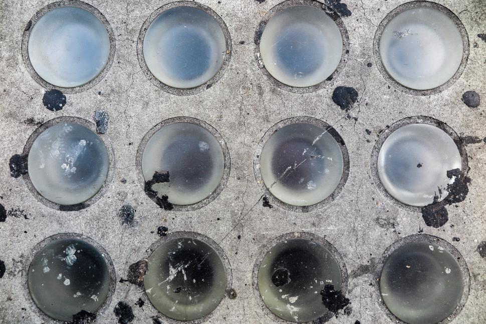 Free Image of Old glass set into sidewalk 
