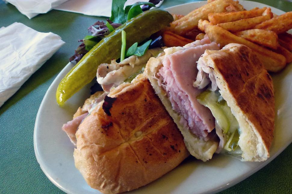 Free Stock Photo of Cuban Sandwich with Fries, Pickles and Greens