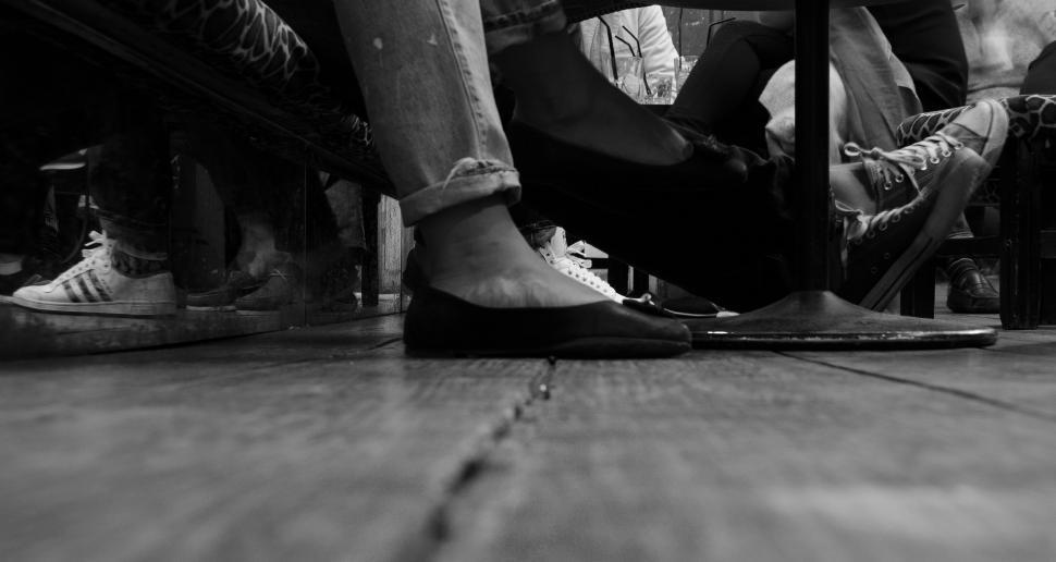 Free Image of People Sitting on a Bench in Black and White 
