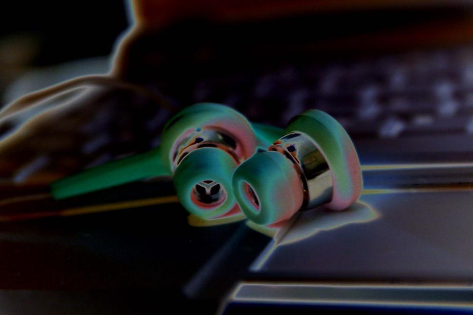 Free Image of Ear Buds on Computer Keyboard 