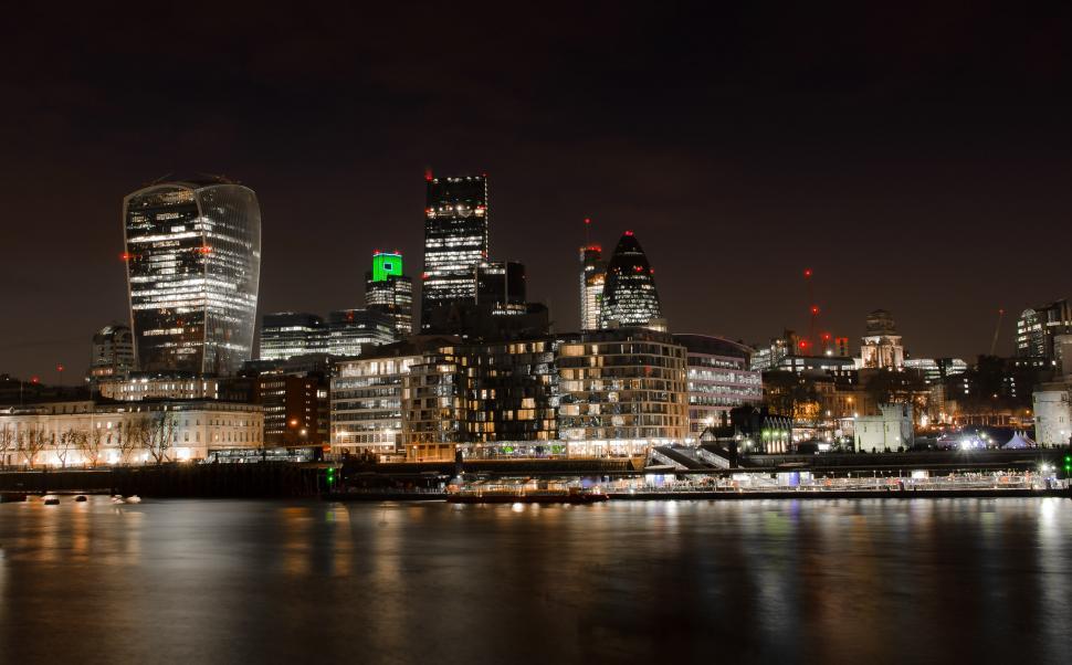 Free Image of Vibrant Green Light Shining on City Skyline at Night 