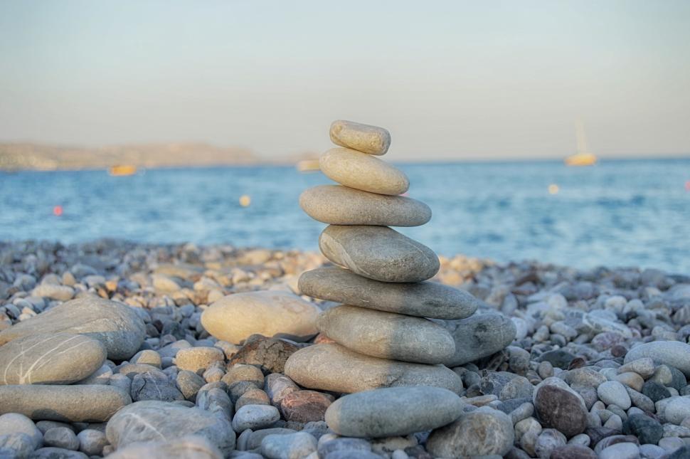 Free Stock Photo of Pyramid of stone on the stone beach