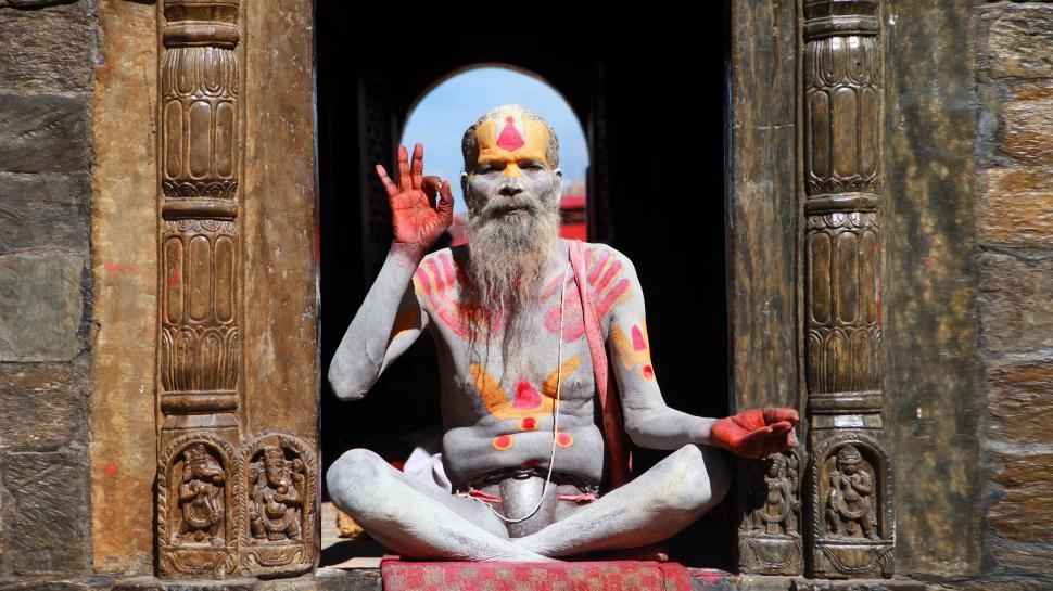 Free Image of Statue of a Man Sitting in a Doorway 