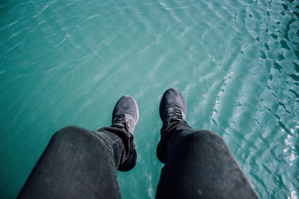 Free Image of Person Standing in Front of a Body of Water 