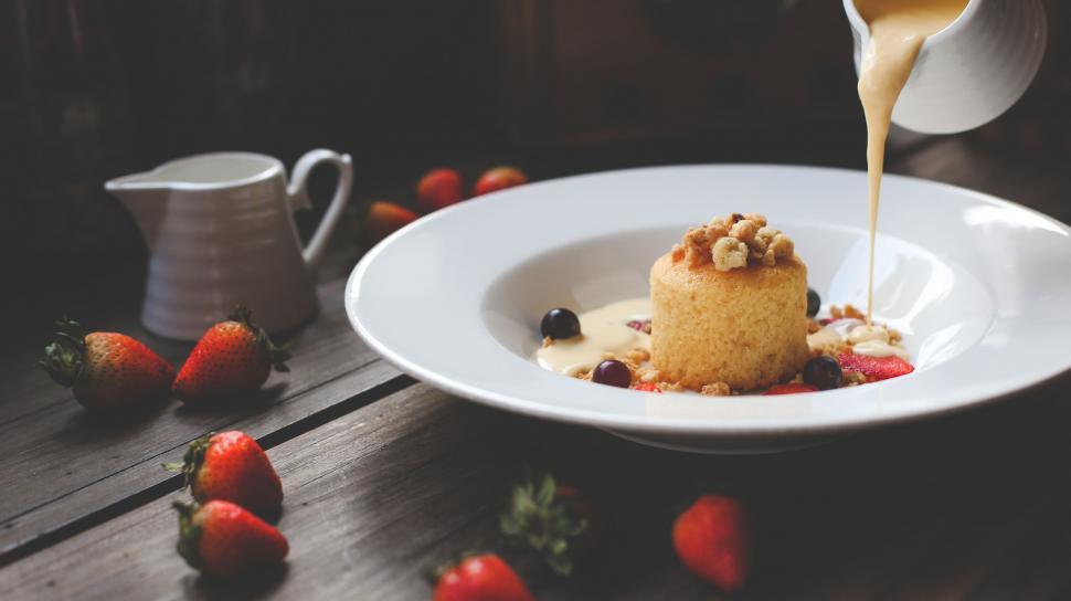 Free Image of Person Pouring Syrup on Dessert Plate 