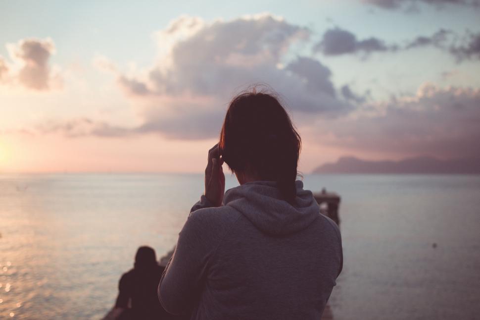 Free Image of Person Standing on Boat Looking Out at Ocean 
