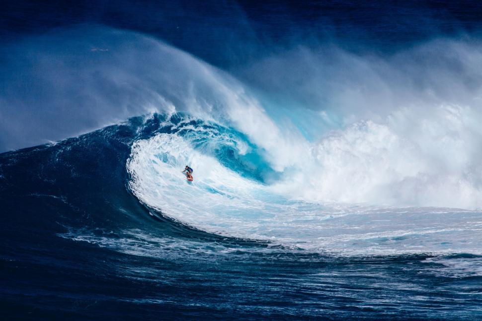 Free Image of Man Riding Wave on Surfboard 