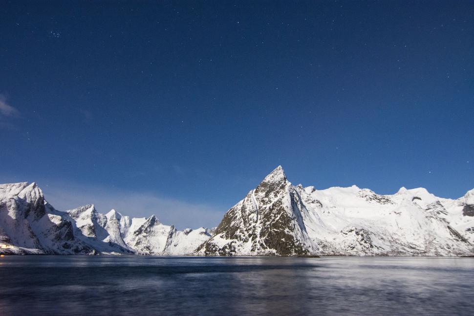 Free Image of Snow Covered Mountain Range With Body of Water 