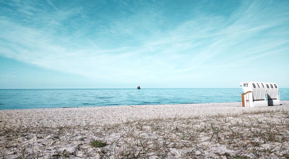 Free Image of A Bench on Sandy Beach 