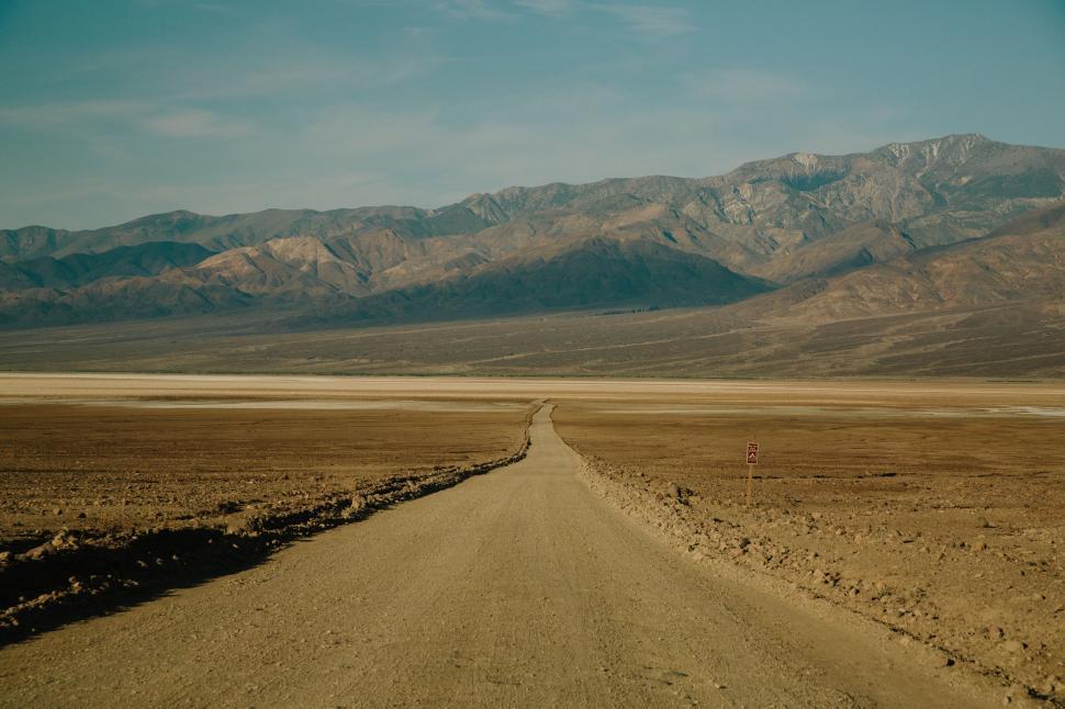 Free Image of Dirt Road With Mountains in Background 