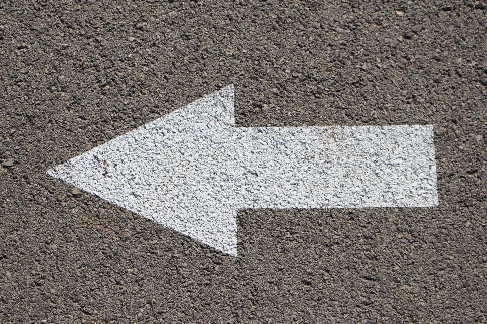 Free Image of White Arrow Painted on Concrete Surface 