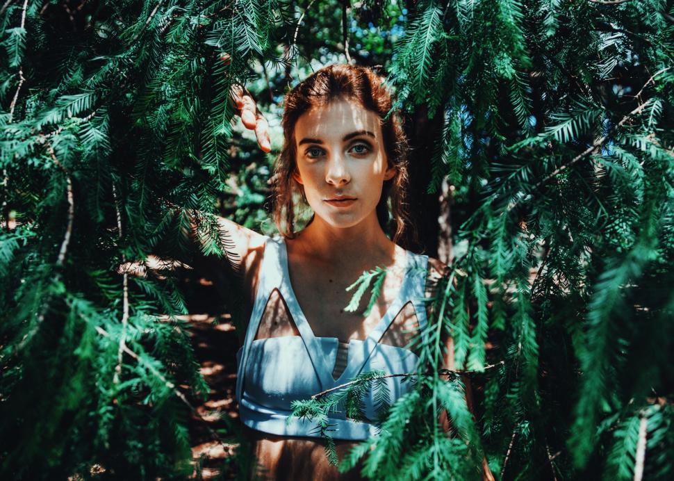 Free Image of Woman Standing in the Middle of a Forest 