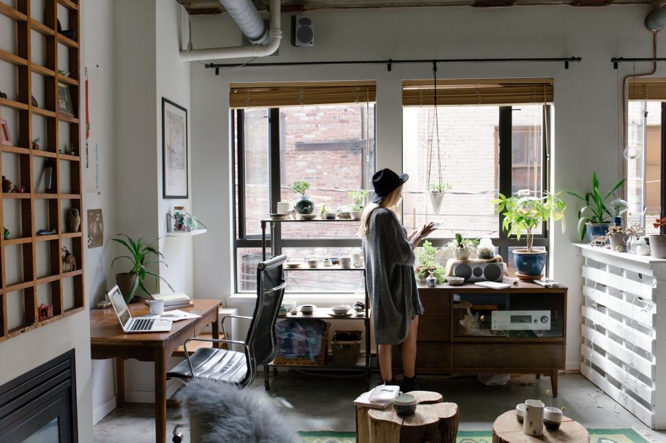 Free Image of Woman Standing in Room With Fireplace 
