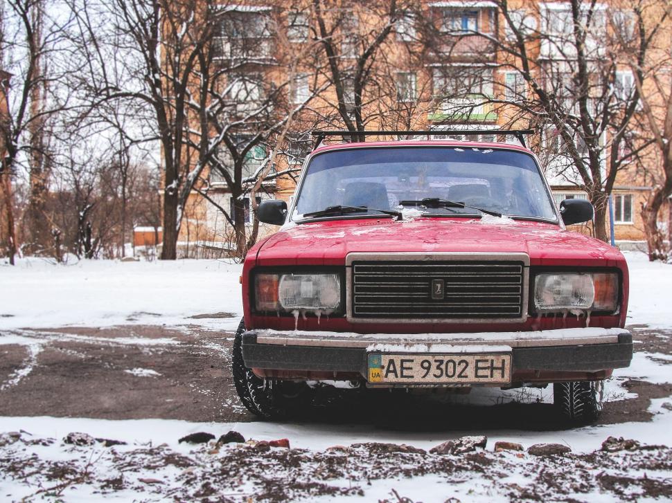 Free Image of Red Car Parked in Snow 