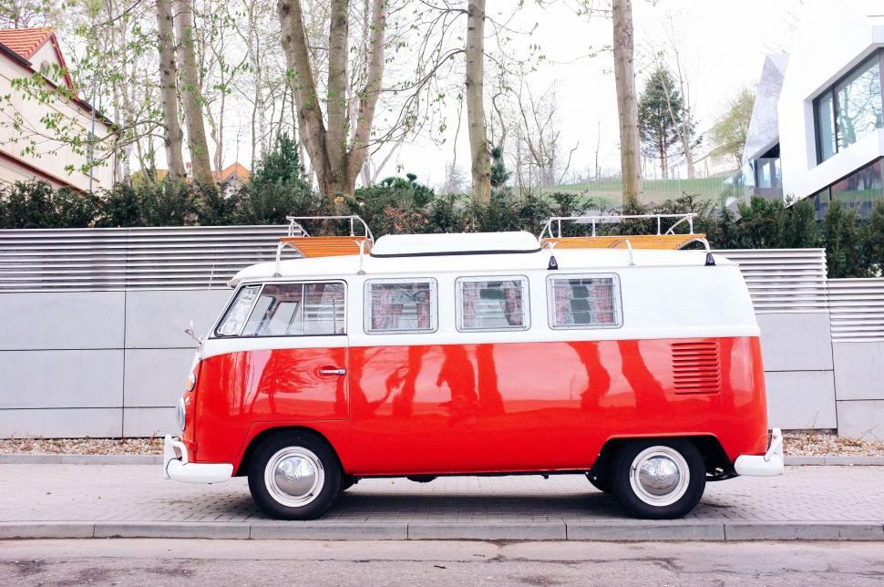 Free Image of Red and White Van Parked on Side of Road 