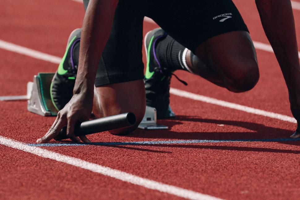 Free Image of Close Up of Person Tying Shoe on Track 