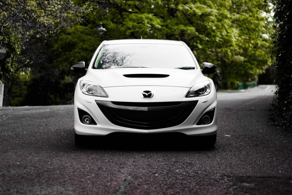 Free Image of White Car Parked on Side of Road 