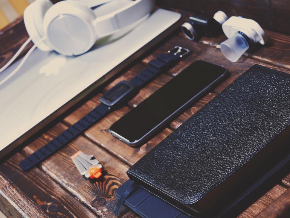 Free Image of Cell Phone and Headphones on Table 