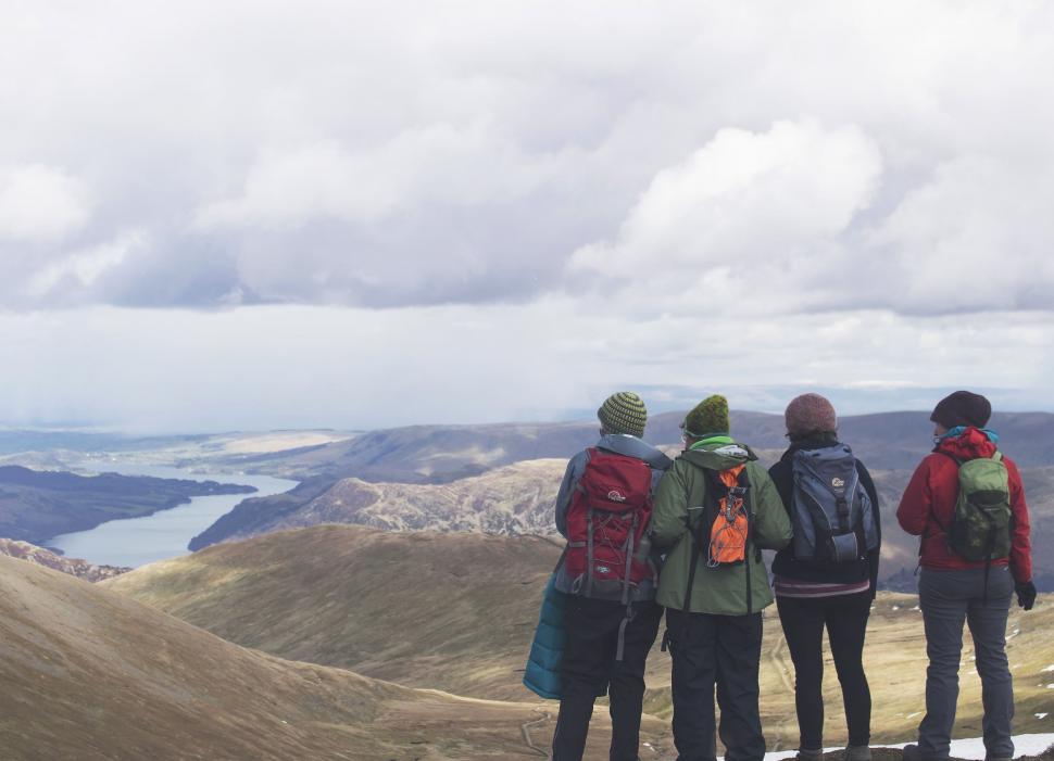 Free Image of Group of People Standing on Top of a Mountain 