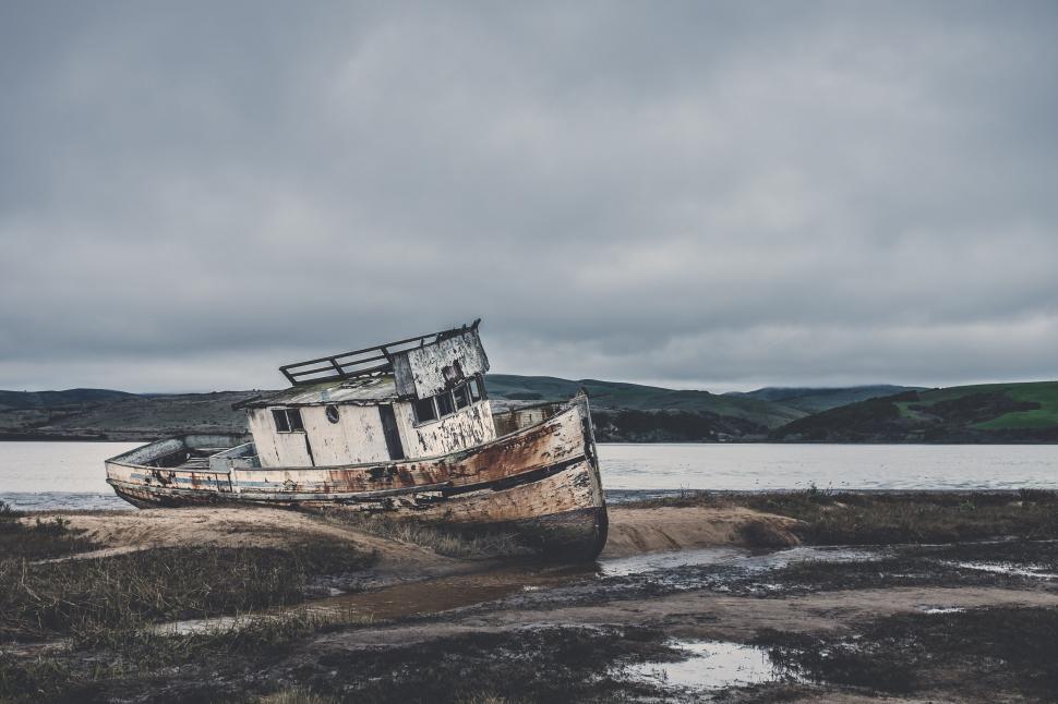 Free Stock Photo of Boat Resting on Beach by Waters Edge