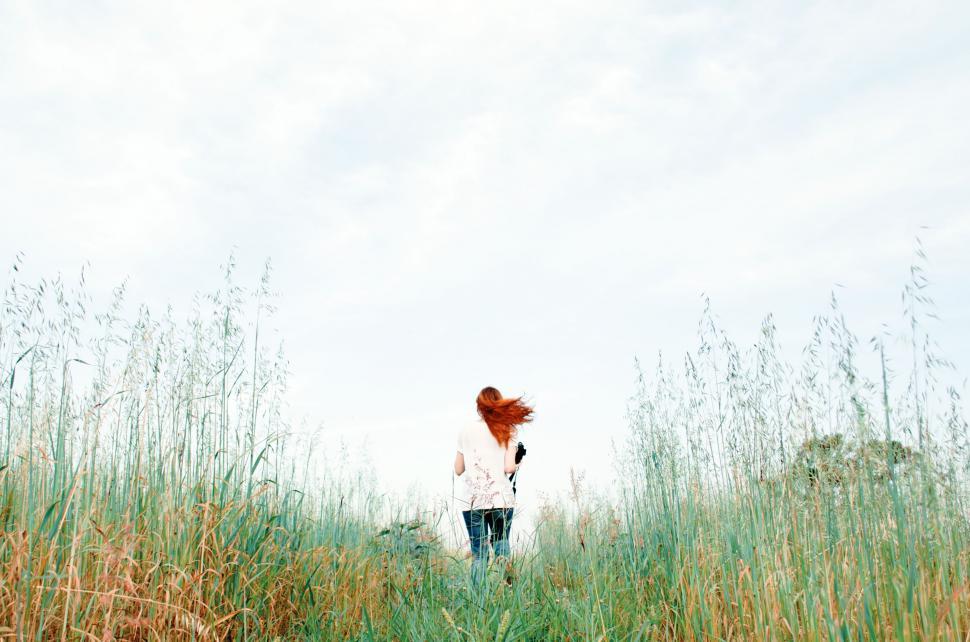 Free Image of Woman Standing in Field of Tall Grass 