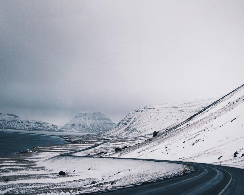 Free Image of Snowy Road With Mountain Background 