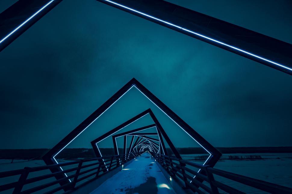 Free Image of Person Walking Down a Long Dark Hallway 