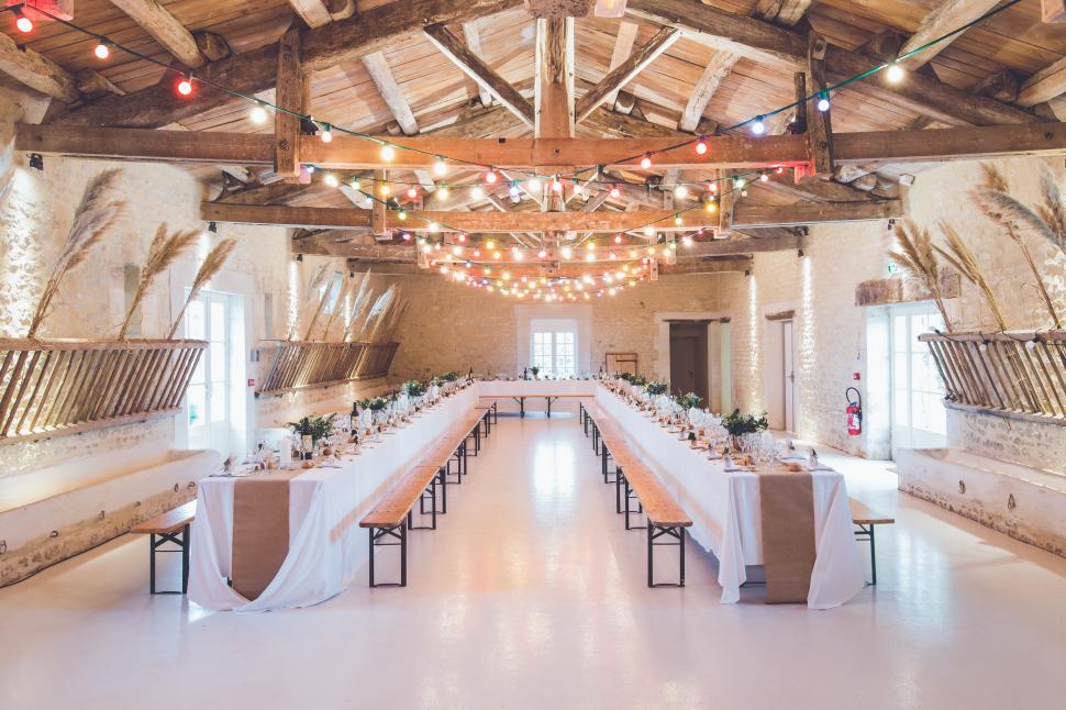 Free Image of Elegant Banquet Hall With Long Tables and Hanging Lights 