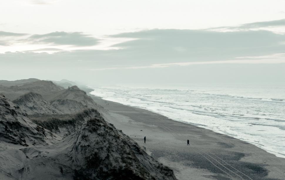 Free Image of People Walking on the Beach 