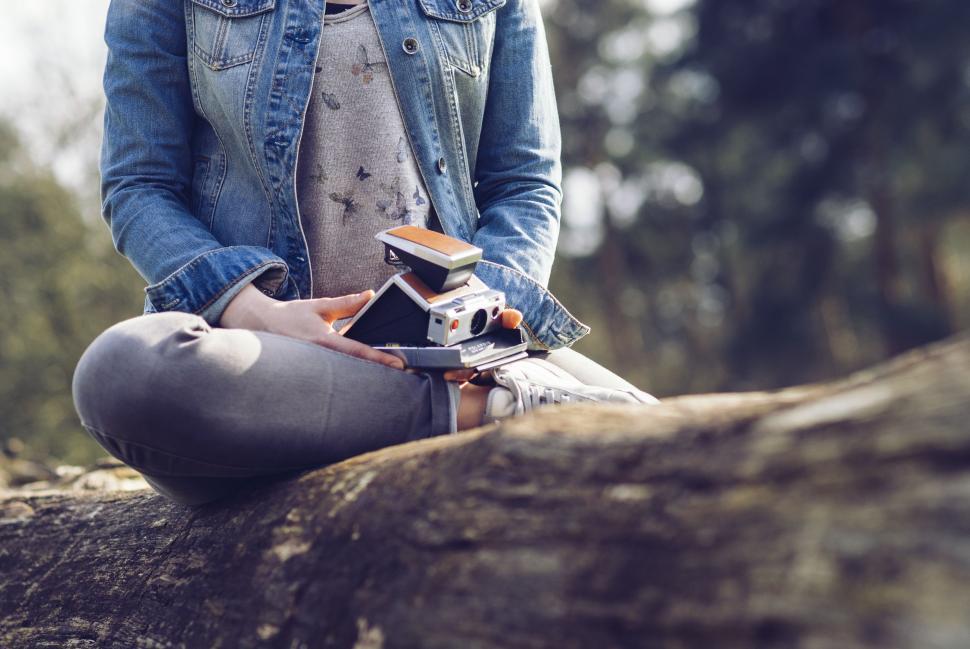 Free Image of Person Sitting on Log With Skateboard 