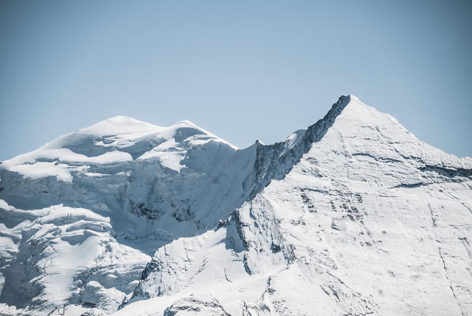 Free Image of Majestic Snow-Covered Mountain Under Blue Sky 