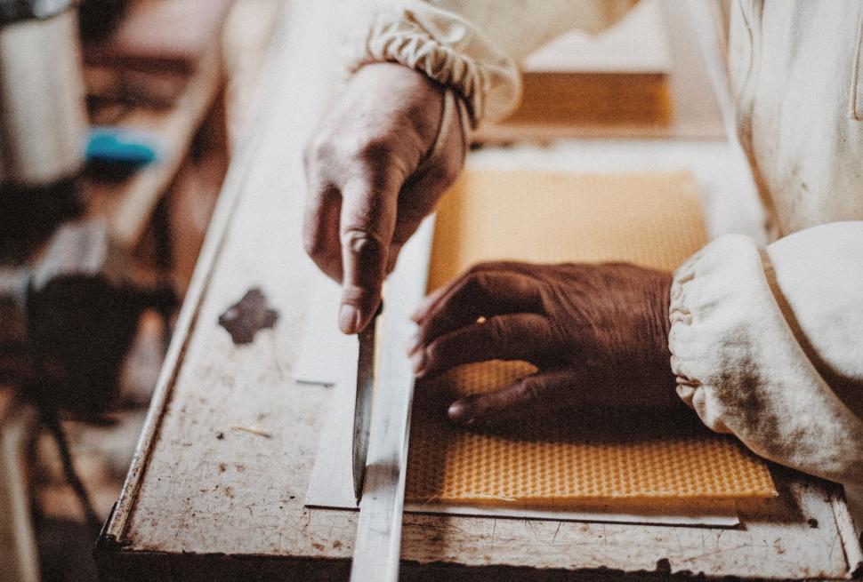 Free Image of Person Cutting Wood With a Knife 