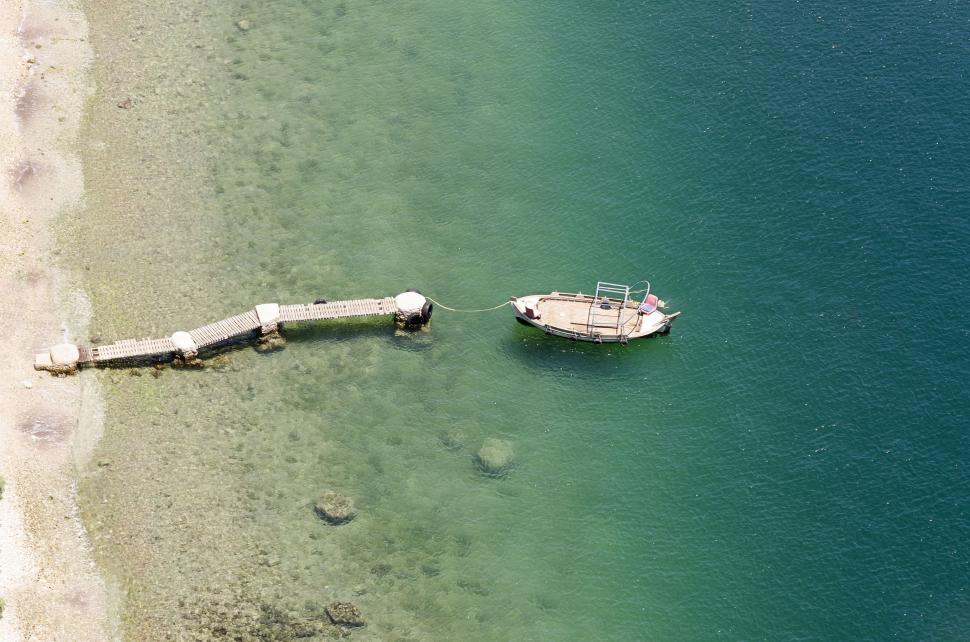 Free Image of Small Boat Floating on Body of Water 