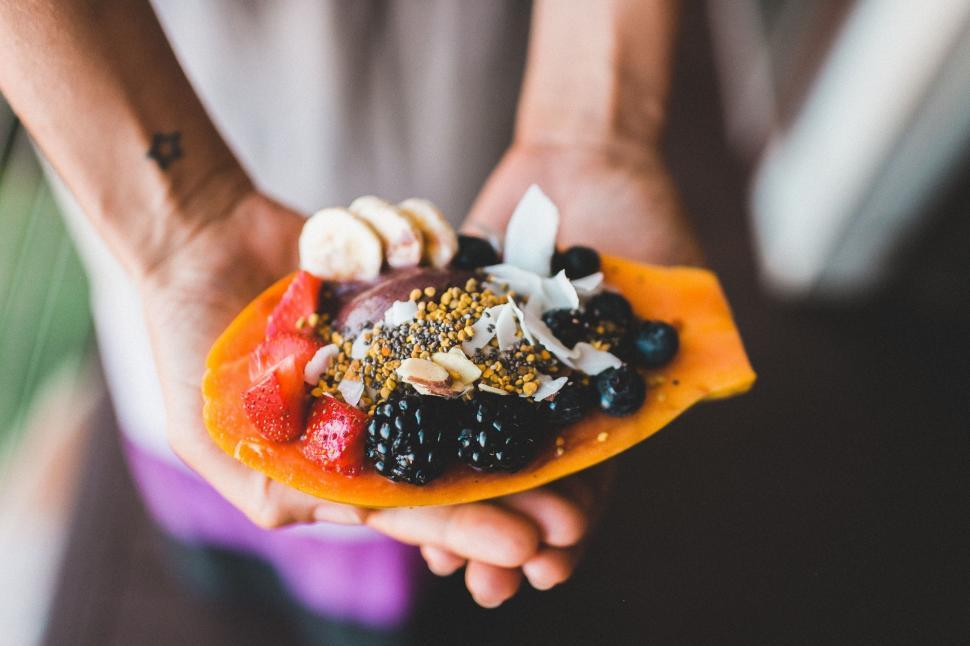 Free Image of Person Holding Piece of Fruit 