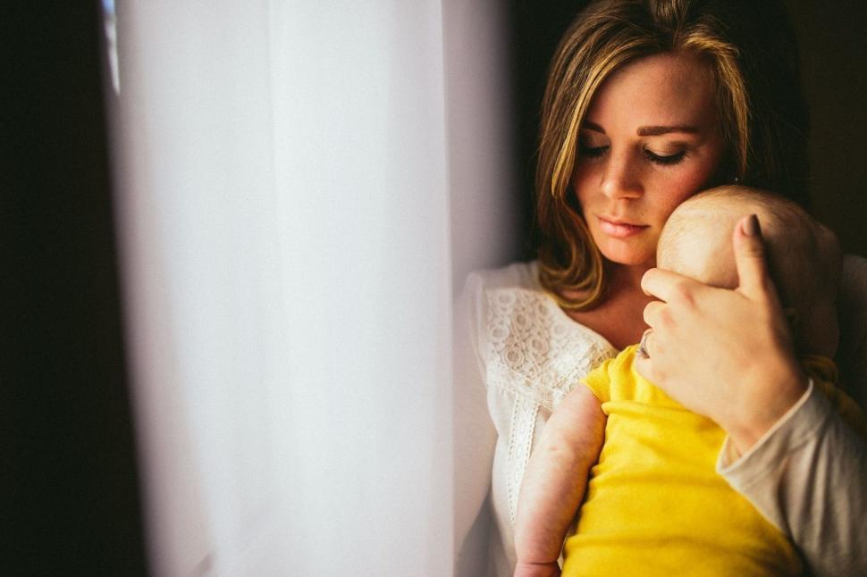 Free Image of Woman Holding Baby in Arms 