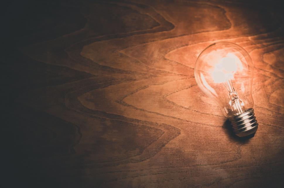 Free Image of Light Bulb on Wooden Table 